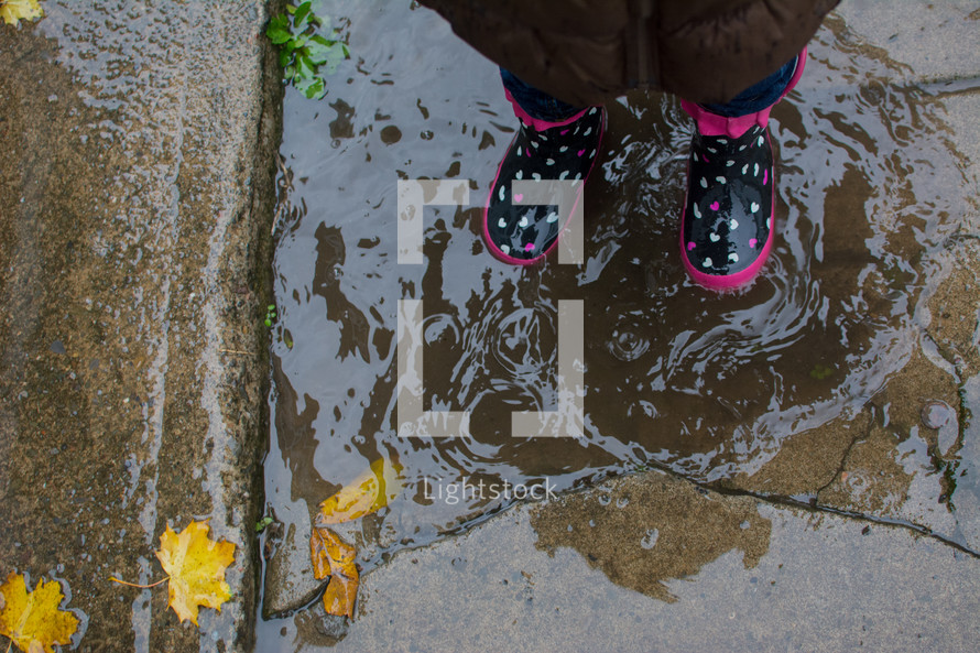 a girl in rain boots 