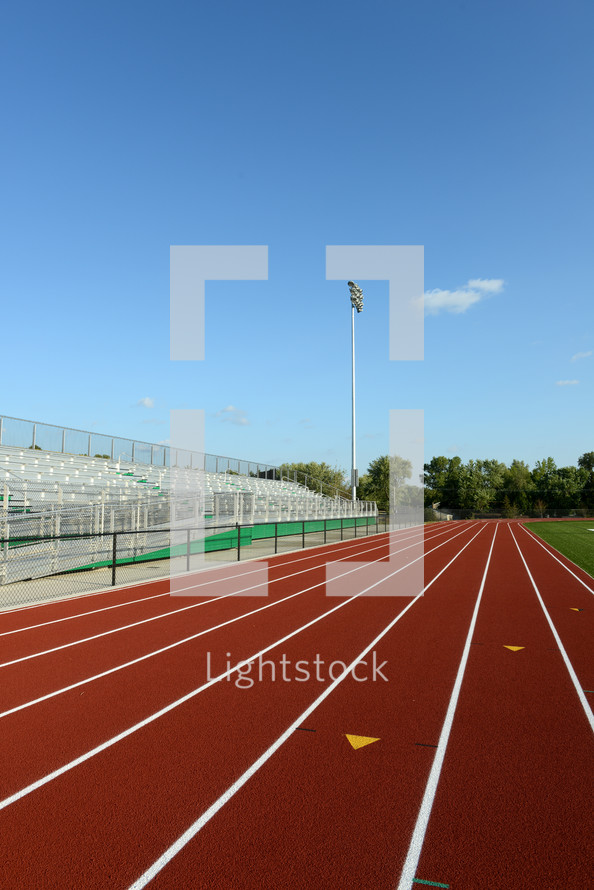 An empty track and bleachers.