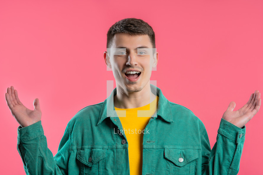 Shocked man glad, he screaming WOW. Impressed guy trying to get attention. Concept of summer sale, profitable offer. Excited happy on pink background. High quality