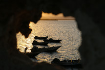silhouettes of boats along a shore in Haiti 