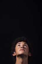 a teen boy looking up to God 