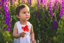 a toddler in a field of flowers 