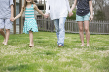 family walking holding hands outdoors 