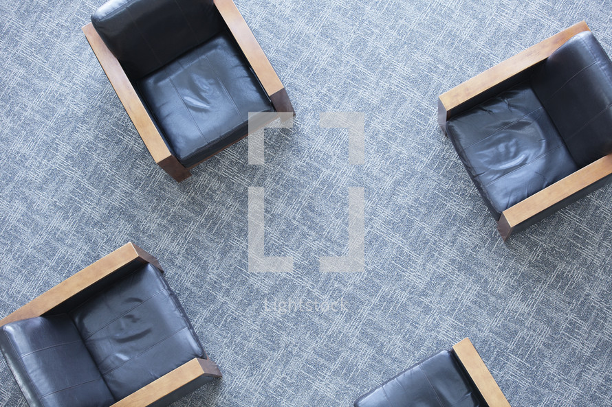 Aerial view of four chairs on carpet.