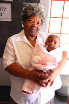 grandmother holding her infant granddaughter 