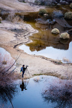 photographer with a tripod photographing nature 
