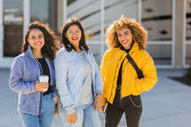 smiling young women standing together 