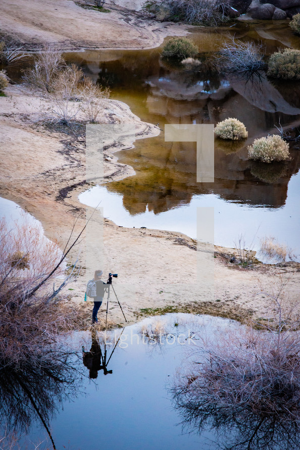 photographer with a tripod photographing nature 