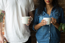 a couple holding coffee mug