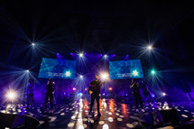 Musicians on stage leading a worship service.