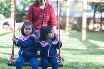 little girls on a swing 