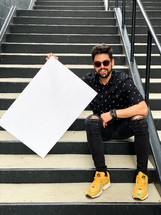 man with a blank poster board 