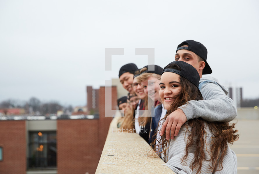 group of teens looking over a parking deck 