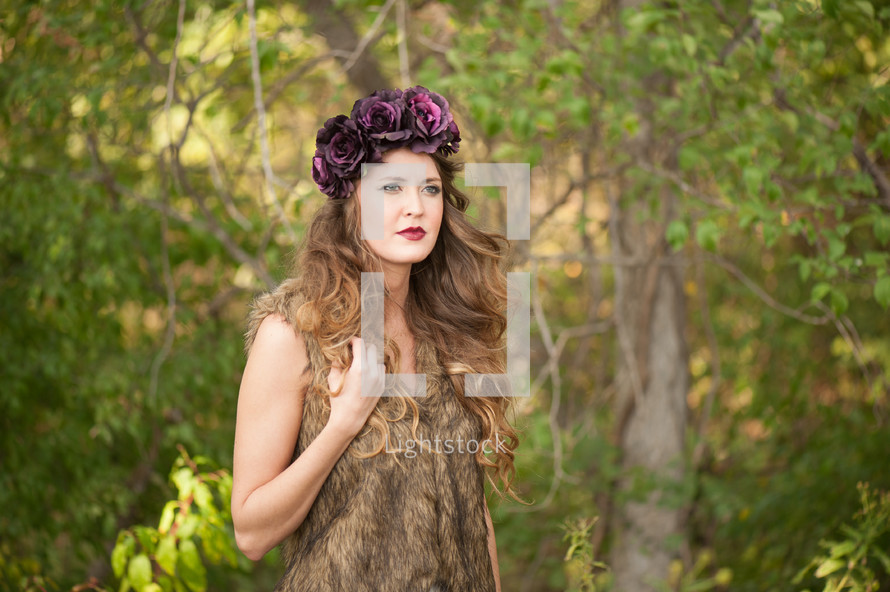 woman in a fur vest and flower hat 