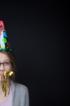 a young woman in a party hat 