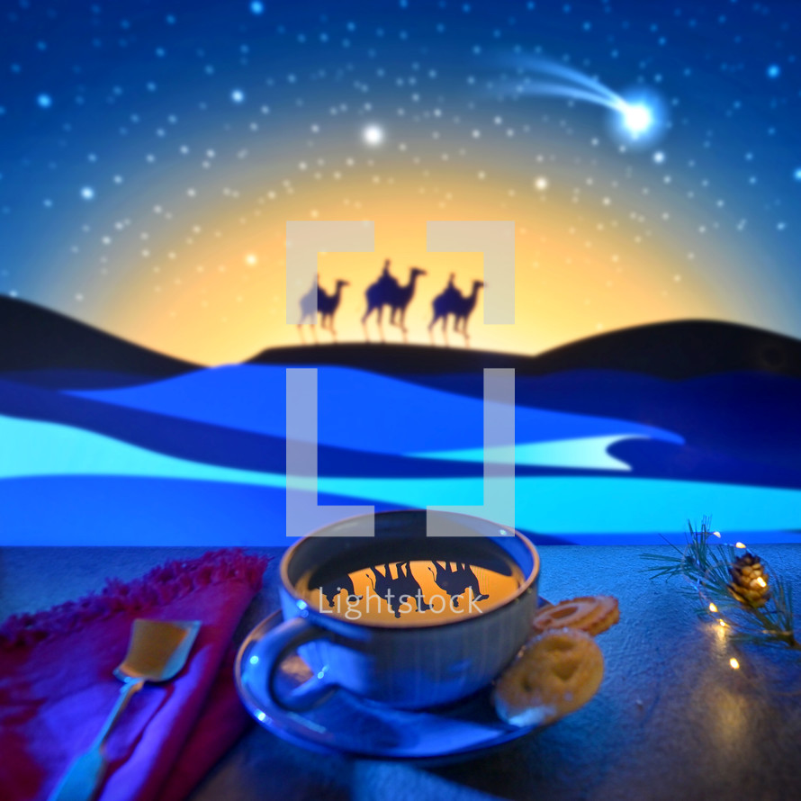 Wisemen on camels reflected in a mug against night sky