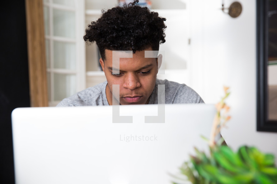 student in front of a laptop computer 
