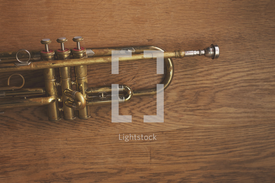 an old brass trumpet on table with copyspace