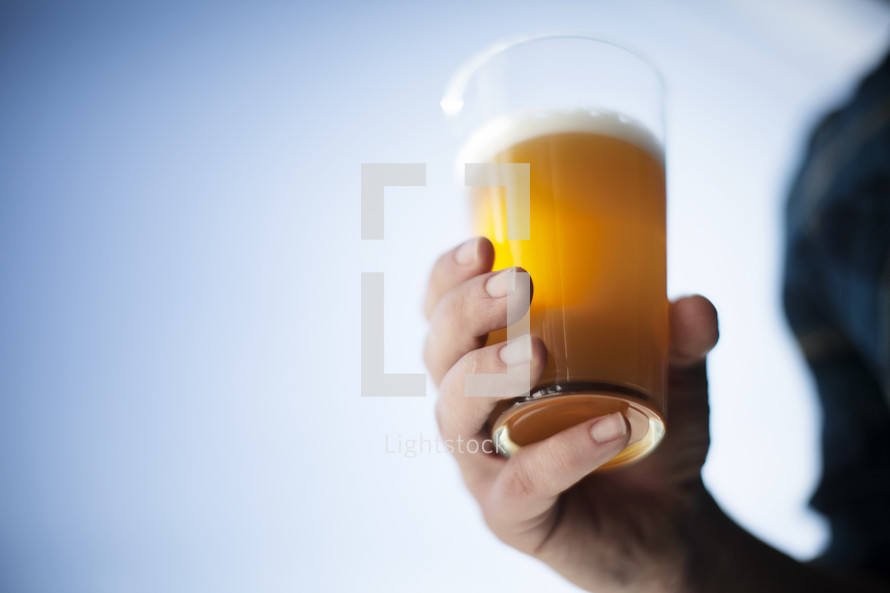 man holding a beer glass 