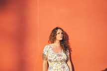 woman standing in front of a red wall 