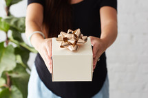 a woman giving a gift 