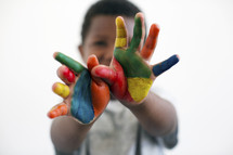 a little boy with painted hands 