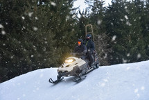Snowmobiling Through Snowy Mountains at Twilight