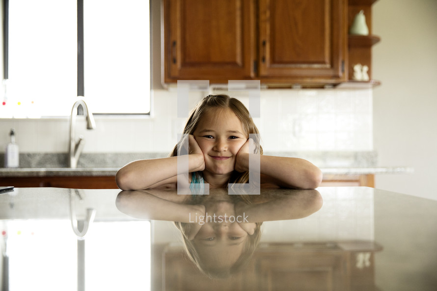 a little girl in a kitchen 