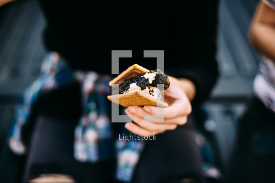 a woman eating s'mores 