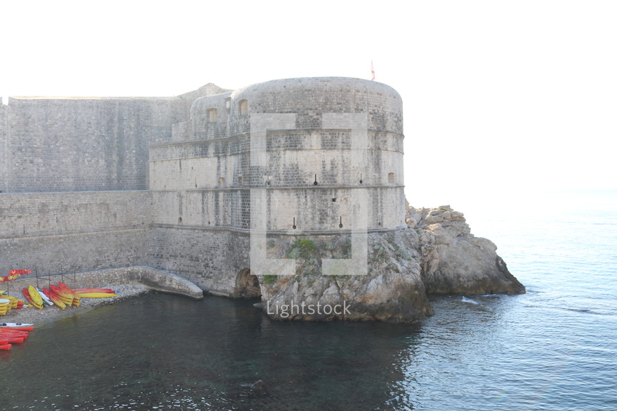 fortress walls along a shore 
