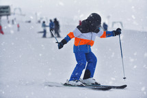 Young Skier Skis Through The Snowy Flurry 