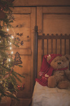 teddy bear in a chair and Christmas tree