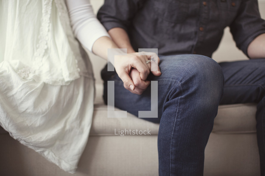 Closeup of couple's hands while making up after an argument. 
