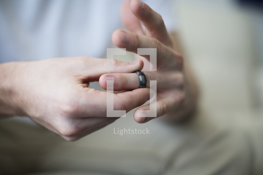 a man taking off his wedding ring.
