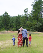 Family standing in a field.