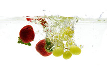 strawberries and grapes under water 