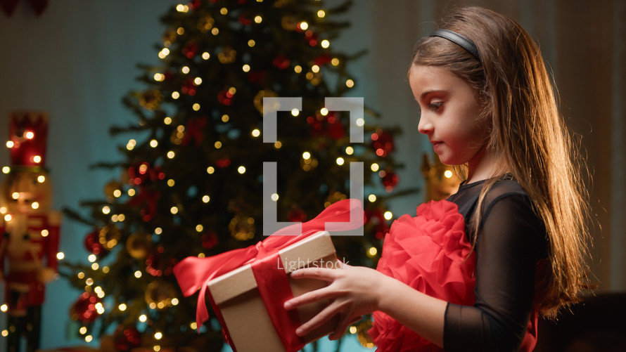 Young girl receiving present from Santa Claus 
