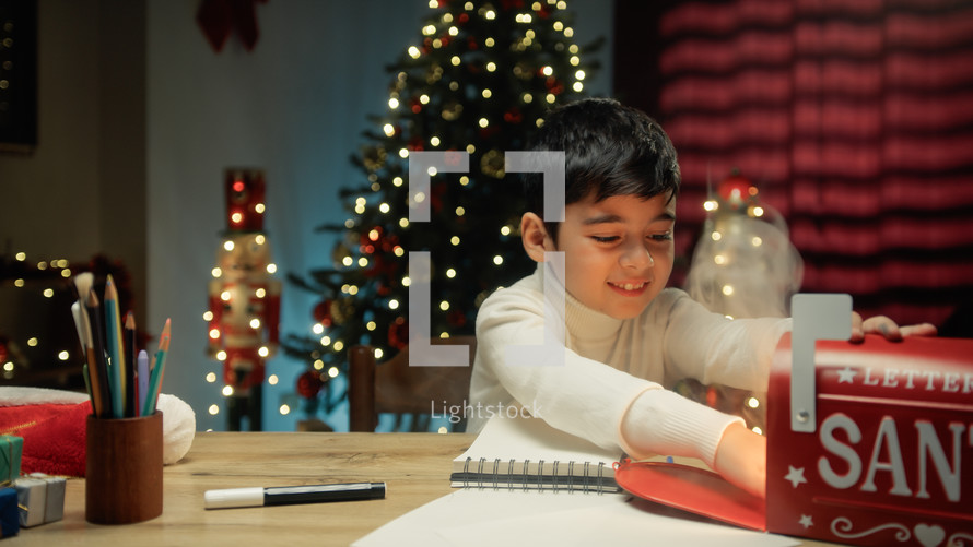 Kid sending Christmas letter to Santa Claus letterbox
