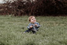 toddler sitting in grass
