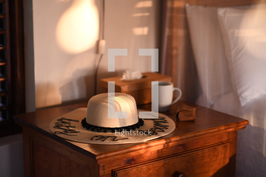 straw hat on a night stand 