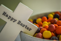 Easter candy and a cross that has Happy Easter written on it