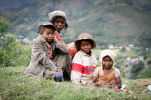 children sitting in a field 
