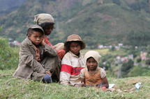 children sitting in a field 