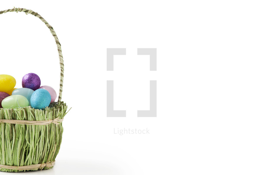 Easter eggs in a basket made with grass.
