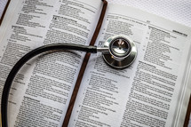 stethoscope on the pages of Bible 