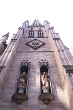 looking up at a cathedral exterior walls 
