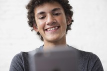 teen boy texting on a cellphone 