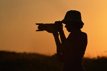 silhouette of a photographer with a camera 