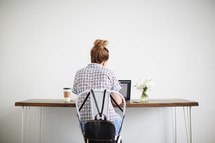 a woman sitting at a computer desk 