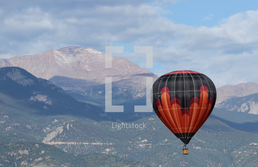 hot air balloon with mountains in the background 